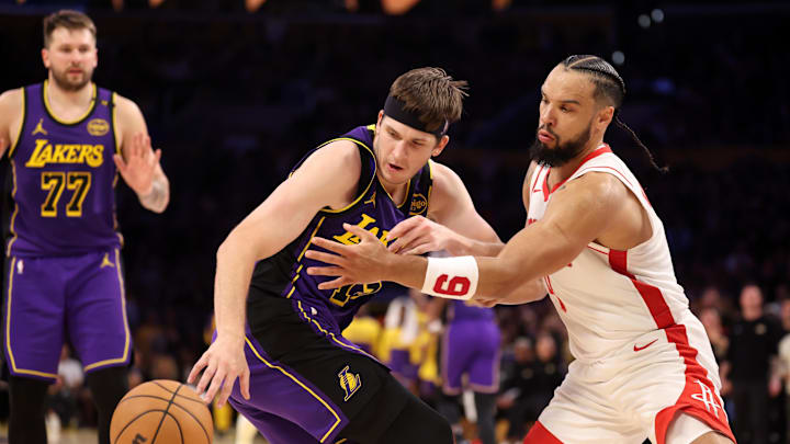 Mar 31, 2025; Los Angeles, California, USA;  Los Angeles Lakers guard Austin Reaves (15) is defended by Houston Rockets forward Dillon Brooks (9) during the fourth quarter at Crypto.com Arena. Mandatory Credit: Kiyoshi Mio-Imagn Images