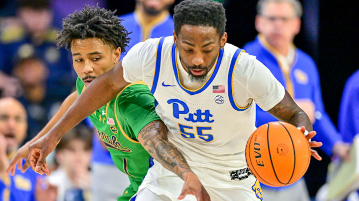 Feb 22, 2025; South Bend, Indiana, USA; Pittsburgh Panthers forward Zack Austin (55) is fouled by Notre Dame Fighting Irish guard Julian Roper II (1) in the first half at the Purcell Pavilion. Mandatory Credit: Matt Cashore-Imagn Images