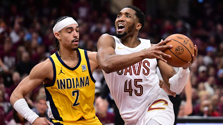 May 4, 2025; Cleveland, Ohio, USA; Cleveland Cavaliers guard Donovan Mitchell (45) drives to the basket against Indiana Pacers guard Andrew Nembhard (2) during the second half in game one of the second round for the 2025 NBA Playoffs at Rocket Arena. Mandatory Credit: Ken Blaze-Imagn Images