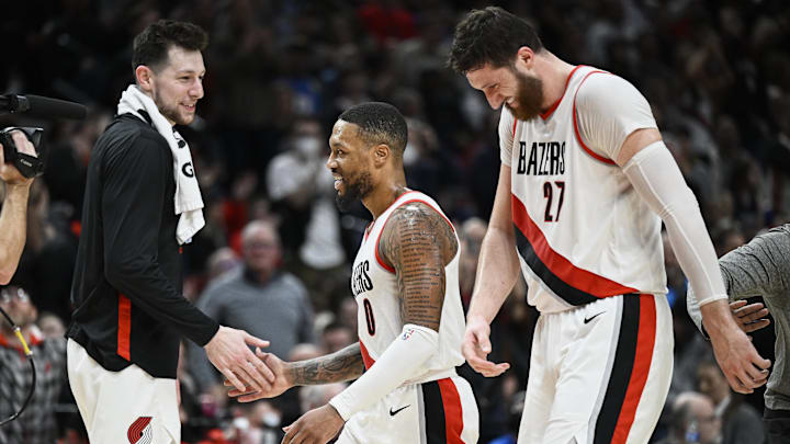 Jan 14, 2023; Portland, Oregon, USA; Portland Trail Blazers guard Damian Lillard (0) laughs with forward Drew Eubanks (24), left, and center Jusuf Nurkic (27) during a time out against the Dallas Mavericks at Moda Center. Mandatory Credit: Troy Wayrynen-Imagn Images