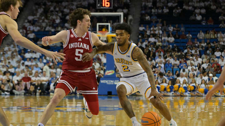 Jan 31, 2026; Los Angeles, California, USA;  UCLA Bruins guard Donovan Dent (2) is defended by Indiana Hoosiers guard Conor Enright (5) as he drives to the basket in the first half at Pauley Pavilion presented by Wescom Financial. Mandatory Credit: Jayne Kamin-Oncea-Imagn Images