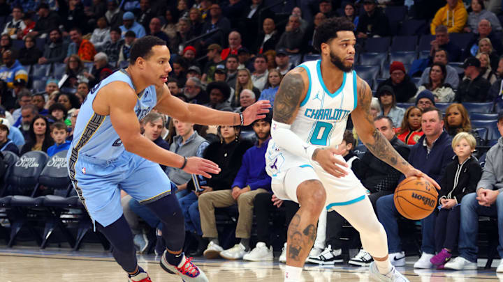 Jan 22, 2025; Memphis, Tennessee, USA; Charlotte Hornets forward Miles Bridges (0) dribbles as Memphis Grizzlies guard Desmond Bane (22) defends during the first quarter at FedExForum. Mandatory Credit: Petre Thomas-Imagn Images