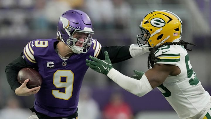 Minnesota Vikings quarterback J.J. McCarthy (9) stiff-arms Green Bay Packers linebacker Ty'Ron Hopper (59) after a seven yard run during the first quarter of their game Sunday, January 4, 2026 at U.S. Bank Stadium in Minneapolis, Minnesota.