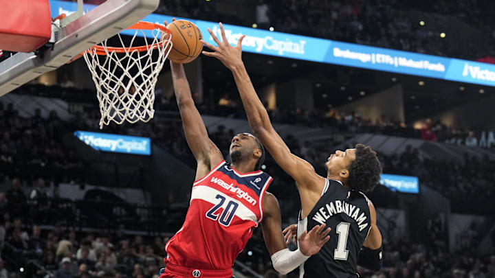Nov 13, 2024; San Antonio, Texas, USA; Washington Wizards forward Alex Sarr (20) goes up to dunk while defended by San Antonio Spurs center Victor Wembanyama (1) during the second half at Frost Bank Center. Mandatory Credit: Scott Wachter-Imagn Images