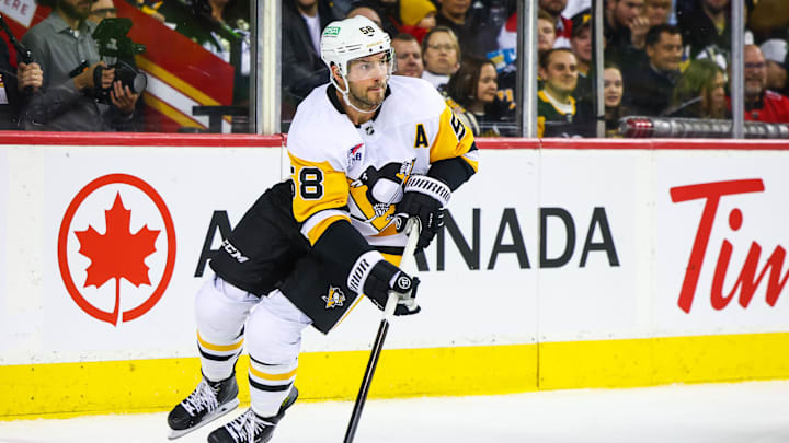 Oct 22, 2024; Calgary, Alberta, CAN; Pittsburgh Penguins defenseman Kris Letang (58) skates with the puck against the Calgary Flames during the second period at Scotiabank Saddledome. Mandatory Credit: Sergei Belski-Imagn Images