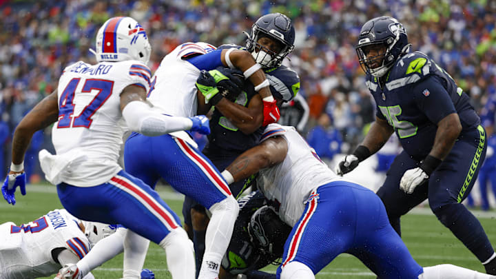 Oct 27, 2024; Seattle, Washington, USA; Buffalo Bills safety Damar Hamlin (3, left) and defensive tackle Eli Ankou (51) tackle Seattle Seahawks running back Kenneth Walker III (9) short of the end zone during the second quarter at Lumen Field. Mandatory Credit: Joe Nicholson-Imagn Images