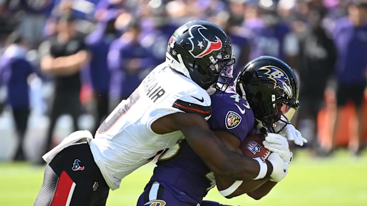 Baltimore Ravens running back Justice Hill is tackled by Houston Texans linebacker Azeez al-Shaair. Baltimore Ravens running back Justice Hill is tackled by Houston Texans linebacker Azeez al-Shaair.