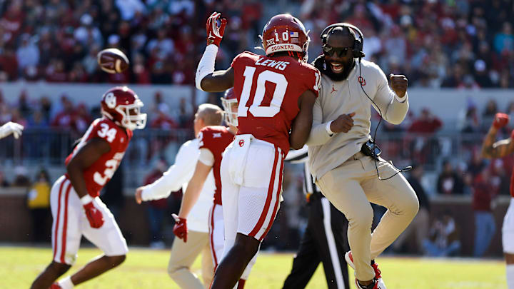 Oklahoma Sooners linebacker Kip Lewis (10) celebrates with Jay Valai, co-defensive coordinator/cornerbacks coach, during a college football game between the University of Oklahoma Sooners (OU) and the TCU Horned Frogs at Gaylord Family-Oklahoma Memorial Stadium in Norman, Okla., Friday, Nov. 24, 2023. Oklahoma won 69-45. Oklahoma Sooners linebacker Kip Lewis (10) celebrates with Jay Valai, co-defensive coordinator/cornerbacks coach, during a college football game between the University of Oklahoma Sooners (OU) and the TCU Horned Frogs at Gaylord Family-Oklahoma Memorial Stadium in Norman, Okla., Friday, Nov. 24, 2023. Oklahoma won 69-45.