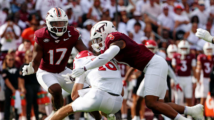 Sep 21, 2024; Blacksburg, Virginia, USA; Rutgers Scarlet Knights quarterback Athan Kaliakmanis (16) is sacked by Virginia Tech Hokies linebacker Sam Brumfield (3) during the first quarter at Lane Stadium. Mandatory Credit: Peter Casey-Imagn Images Sep 21, 2024; Blacksburg, Virginia, USA; Rutgers Scarlet Knights quarterback Athan Kaliakmanis (16) is sacked by Virginia Tech Hokies linebacker Sam Brumfield (3) during the first quarter at Lane Stadium. Mandatory Credit: Peter Casey-Imagn Images