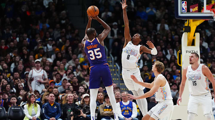 Dec 23, 2024; Denver, Colorado, USA; Denver Nuggets forward Peyton Watson (8) defends on Phoenix Suns forward Kevin Durant (35) in the second half at Ball Arena. Mandatory Credit: Ron Chenoy-Imagn Images