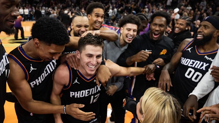 Nov 21, 2025; Phoenix, Arizona, USA; Phoenix Suns guard Collin Gillespie (12) celebrates with teammates after hitting the game winning shot against the Minnesota Timberwolves in the second half of an NBA Cup game at Mortgage Matchup Center. Mandatory Credit: Mark J. Rebilas-Imagn Images