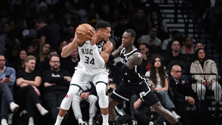 Dec 8, 2024; Brooklyn, New York, USA; Milwaukee Bucks forward Giannis Antetokounmpo (34) posts up against Brooklyn Nets guard Dennis Schroder (17) during the first half at Barclays Center. Mandatory Credit: John Jones-Imagn Images
