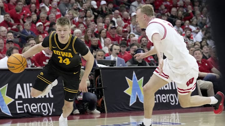 Iowa guard Bennett Stirtz (14) drives on Wisconsin guard Andrew Rohde (7) during the first half of the game Sunday, February 22, 2026 at the Kohl Center in Madison, Wisconsin.