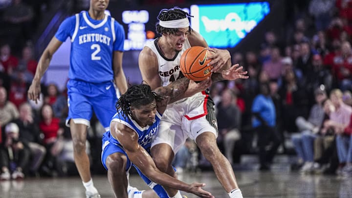 Jan 7, 2025; Athens, Georgia, USA; Georgia Bulldogs forward Asa Newell (14) and Kentucky Wildcats guard Otega Oweh (00) battle for the ball during the second half at Stegeman Coliseum. Mandatory Credit: Dale Zanine-Imagn Images