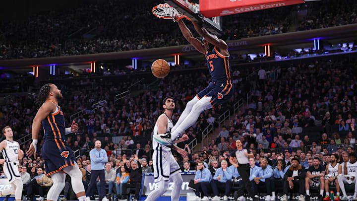 Feb 6, 2024; New York, New York, USA; New York Knicks forward Precious Achiuwa (5) dunks in front of Memphis Grizzlies forward Santi Aldama (7) during the first half at Madison Square Garden. Mandatory Credit: Vincent Carchietta-USA TODAY Sports