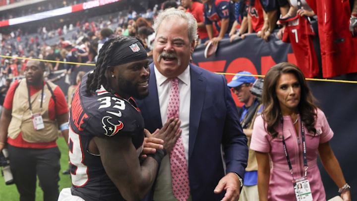 Sep 29, 2024; Houston, Texas, USA; Houston Texans running back Dare Ogunbowale (33) hugs Houston Texans owner Cal McNair after defeating the Jacksonville Jaguars  at NRG Stadium. Mandatory Credit: Thomas Shea-Imagn Images