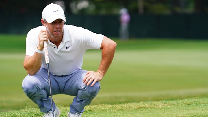 Aug 27, 2023; Atlanta, Georgia, USA; Rory McIlroy lines up his putt on the first green  during the
