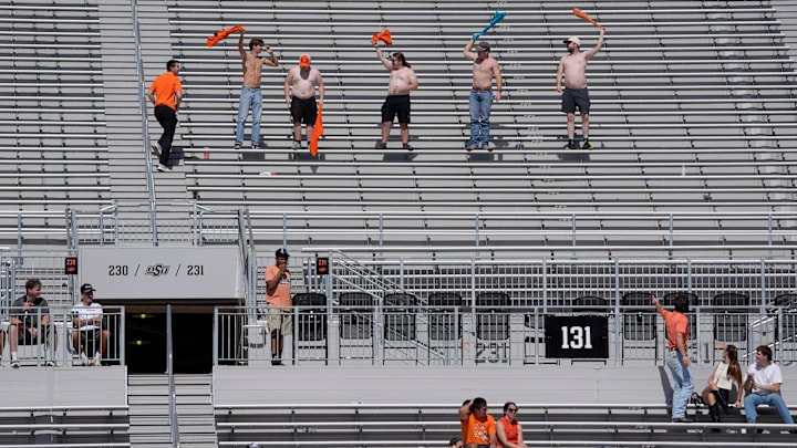 Oklahoma State fans cheer with their shirts off during a college football game between the Oklahoma State Cowboys (OSU) and the Houston Cougars at Boone Pickens Stadium in Stillwater, Okla., Saturday, Oct. 11, 2025. Houston won 39-17.