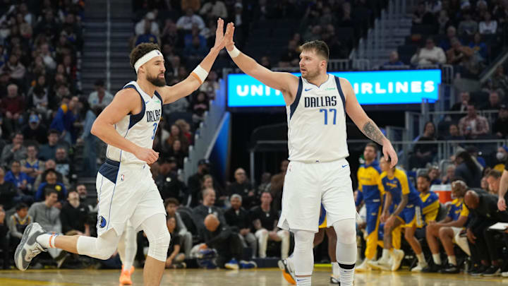 Dallas Mavericks guard Klay Thompson is congratulated by guard Luka Doncic.