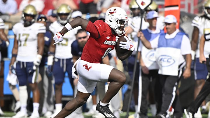 Sep 21, 2024; Louisville, Kentucky, USA;  Louisville Cardinals wide receiver Chris Bell (0) runs the ball against the Georgia Tech Yellow Jackets during the first half at L&N Federal Credit Union Stadium. Mandatory Credit: Jamie Rhodes-Imagn Images