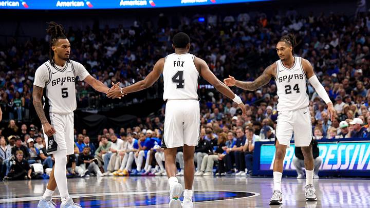 Oct 24, 2026; Dallas, Texas, USA;  San Antonio Spurs guard De'aaron Fox (4) celebrates with San Antonio Spurs guard Stephon Castle (5) and San Antonio Spurs guard Devin Vassell (24) during the second quarter against the Dallas Mavericks at American Airlines Center. 