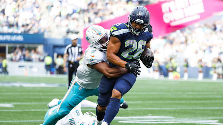Sep 22, 2024; Seattle, Washington, USA; Seattle Seahawks running back Zach Charbonnet (26) rushes for a touchdown against Miami Dolphins linebacker Anthony Walker Jr. (6) during the fourth quarter at Lumen Field. Mandatory Credit: Joe Nicholson-Imagn Images