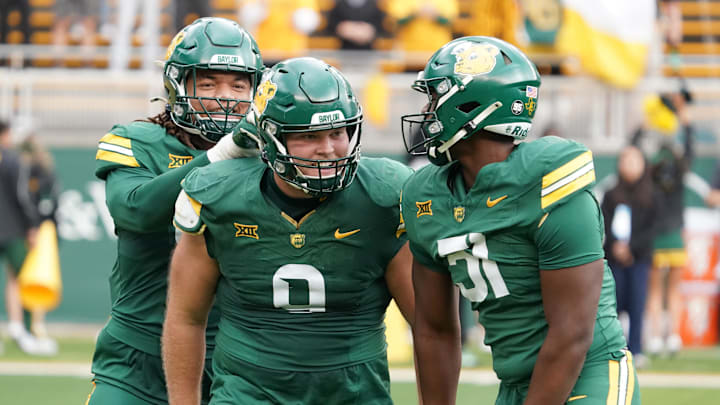 Nov 1, 2025; Waco, Texas, USA; Baylor Bears defensive lineman Cooper Lanz (9) celebrates a sack with teammates during the second half against the UCF Knights at McLane Stadium. Mandatory Credit: Raymond Carlin III-Imagn Images