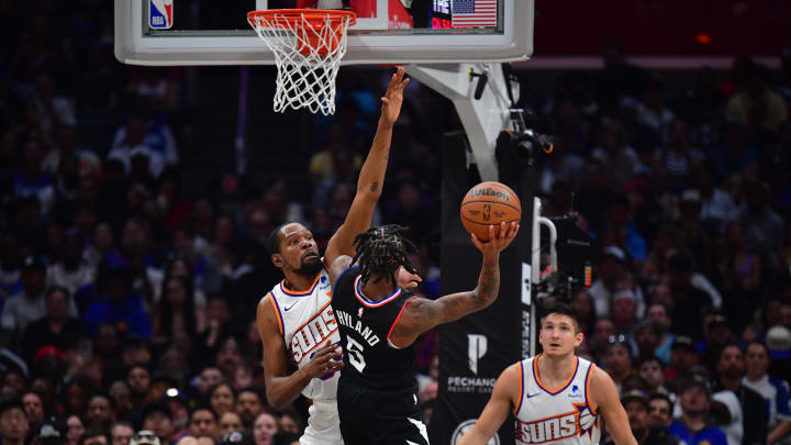 Apr 10, 2024; Los Angeles, California, USA; Los Angeles Clippers guard Bones Hyland (5) shoots against Phoenix Suns forward Kevin Durant (35) during the second half at Crypto.com Arena. Mandatory Credit: Gary A. Vasquez-USA TODAY Sports