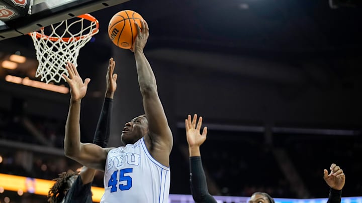 Fousseyni Traore gets a layup over two UCF defenders