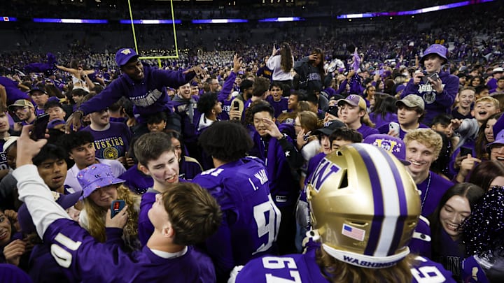 Oct 5, 2024; Seattle, Washington, USA; Washington Huskies fans rush the field to congratulate players following a victory against the Michigan Wolverines at Alaska Airlines Field at Husky Stadium. Mandatory Credit: Joe Nicholson-Imagn Images