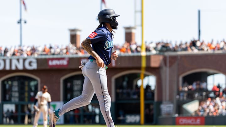 Seattle Mariners shortstop J.P. Crawford (3) is walked in to score during the third inning against the San Francisco Giants at Oracle Park on April 4.