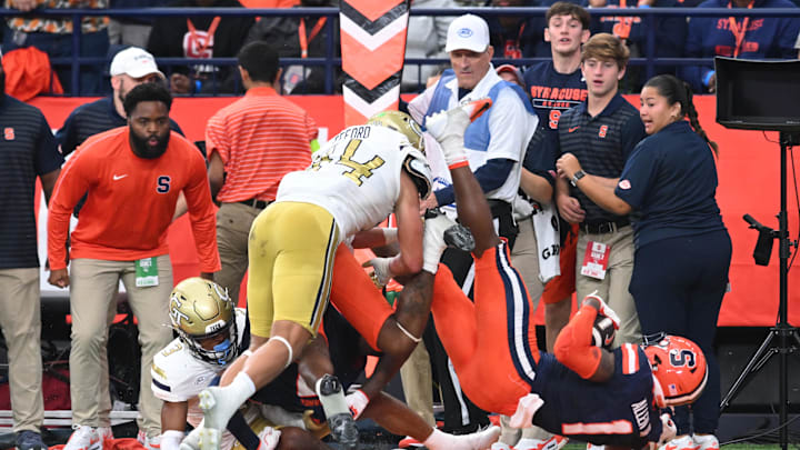 Sep 7, 2024; Syracuse, New York, USA; Syracuse Orange running back LeQuint Allen (1) is tackled by Georgia Tech Yellow Jackets linebacker Kyle Efford (44) in the second quarter at the JMA Wireless Dome. Mandatory Credit: Mark Konezny-Imagn Images
