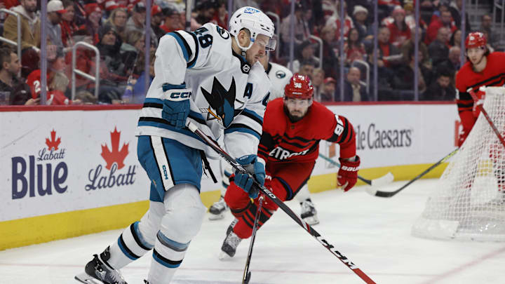 Jan 24, 2023; Detroit, Michigan, USA; San Jose Sharks center Tomas Hertl (48) skates with the puck chased by Detroit Red Wings defenseman Jake Walman (96) in the third period at Little Caesars Arena. Mandatory Credit: Rick Osentoski-USA TODAY Sports