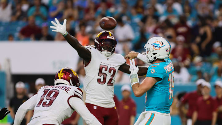Aug 17, 2024; Miami Gardens, Florida, USA; Miami Dolphins quarterback Skylar Thompson (19) throws the football as Washington Commanders linebacker Jamin Davis (52) defends during the second quarter of a preseason game at Hard Rock Stadium. Mandatory Credit: Sam Navarro-USA TODAY Sports