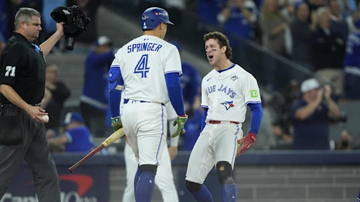 Nov 1, 2025; Toronto, Ontario, CAN; Toronto Blue Jays third baseman Ernie Clement (22) celebrates with right fielder George Springer (4) after scoring in the sixth inning during game seven of the 2025 MLB World Series at Rogers Centre. Mandatory Credit: John E. Sokolowski-Imagn Images