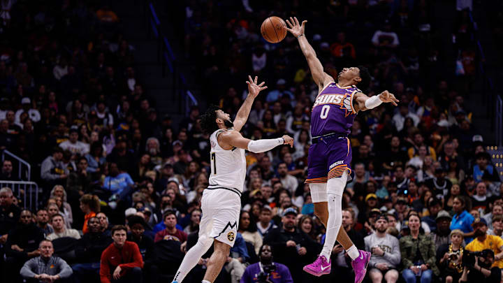 Oct 13, 2024; Denver, Colorado, USA; Denver Nuggets guard Jamal Murray (27) catches a pass against Phoenix Suns forward Ryan Dunn (0) in the second quarter at Ball Arena. Mandatory Credit: Isaiah J. Downing-Imagn Images