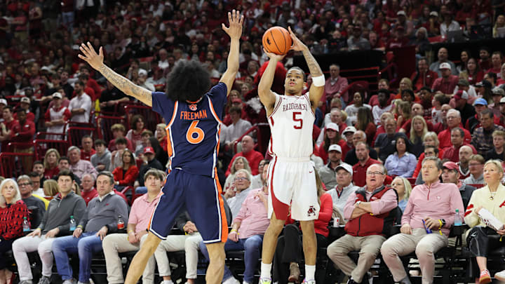 Feb 14, 2026; Fayetteville, Arkansas, USA; Arkansas Razorbacks guard Darius Acuff Jr (5) shoots a three-point shot in the first half as Auburn Tigers guard Elyjah Freeman (6) defends at Bud Walton Arena. Mandatory Credit: Nelson Chenault-Imagn Images