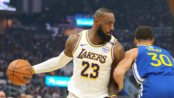 Dec 25, 2024; San Francisco, California, USA; Los Angeles Lakers forward LeBron James (23) dribbles against Golden State Warriors guard Stephen Curry (30) during the first quarter at Chase Center. Mandatory Credit: Darren Yamashita-Imagn Images