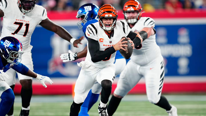 Cincinnati Bengals quarterback Joe Burrow (9) runs past the New York Giants defense as he begins his touchdown run to score the first points of the game, Sunday, October 13, 2024, in East Rutherford.