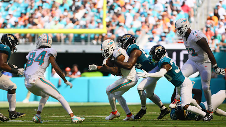 Miami Dolphins running back Raheem Mostert (31) runs with the football against Jacksonville Jaguars linebacker Yasir Abdullah (56) and cornerback Montaric Brown (30) during the fourth quarter at Hard Rock Stadium in Week 1.