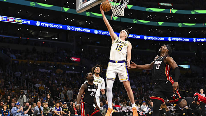Nov 2, 2025; Los Angeles, California, USA; Los Angeles Lakers guard Austin Reaves (15) shoots against Miami Heat center/forward Bam Adebayo (13) and guard Davion Mitchell (45) during the second half at Crypto.com Arena. Mandatory Credit: Jonathan Hui-Imagn Images
