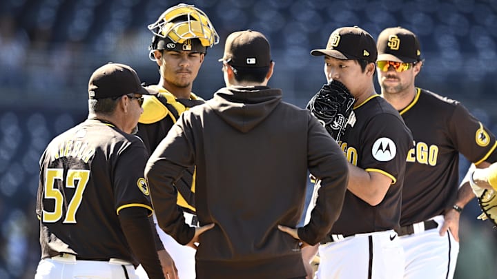 Padres pitching coach Ruben Niebla (57) meets with relief pitcher Woo-Suk Go (second from right) during the ninth inning against the Seattle Mariners at Petco Park on March 26, 2024.