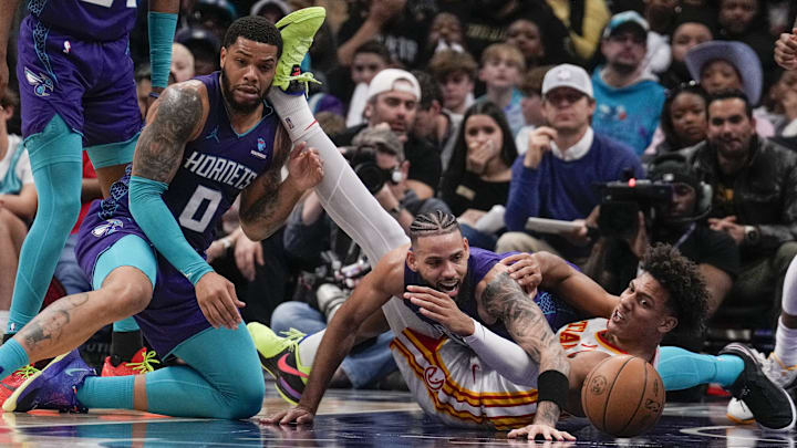 Feb 14, 2024; Charlotte, North Carolina, USA; Atlanta Hawks forward Jalen Johnson (1) and Charlotte Forwards Miles Bridges (0) and Cody Martin