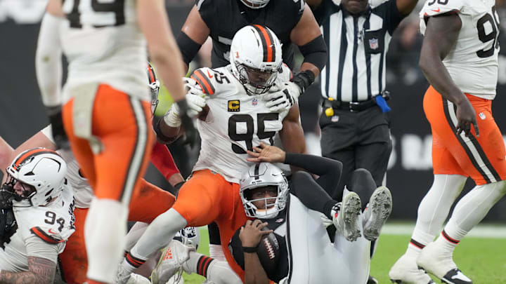 Nov 23, 2025; Paradise, Nevada, USA; Cleveland Browns defensive end Myles Garrett (95) sacks Las Vegas Raiders quarterback Geno Smith (7) in the second half at Allegiant Stadium. Mandatory Credit: Kirby Lee-Imagn Images
