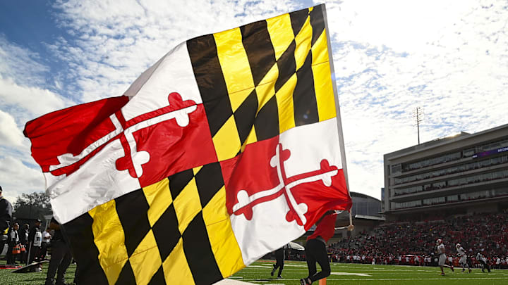Oct 30, 2021; College Park, Maryland, USA;  Maryland Terrapins spirit team runs with a Maryland state flag after a first half touchdown against the Indiana Hoosiers at Capital One Field at Maryland Stadium. Mandatory Credit: Tommy Gilligan-Imagn Images