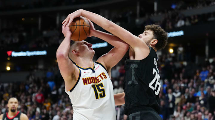 Dec 8, 2023; Denver, Colorado, USA; Houston Rockets center Alperen Sengun (28) blocks a shot by Denver Nuggets center Nikola Jokic (15) in the second half at Ball Arena. Mandatory Credit: Ron Chenoy-Imagn Images