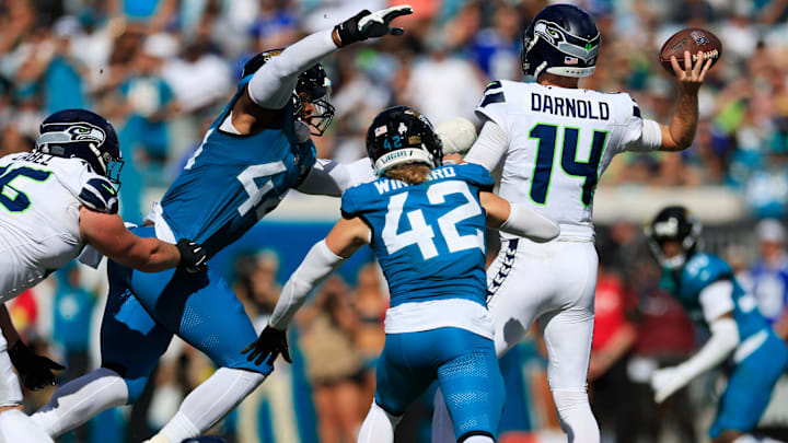 Jacksonville Jaguars defensive end Travon Walker (44) pressures Seattle Seahawks quarterback Sam Darnold (14) as Jacksonville Jaguars safety Andrew Wingard (42) pressures during the fourth quarter of an NFL football matchup, Sunday, Oct. 12, 2025, at EverBank Stadium in Jacksonville, Fla. The Seahawks defeated the Jaguars 20-12. [Corey Perrine/Florida Times-Union]