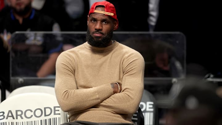 Los Angeles Lakers forward LeBron James watches from the bench during the fourth quarter against the Brooklyn Nets. Los Angeles Lakers forward LeBron James watches from the bench during the fourth quarter against the Brooklyn Nets.