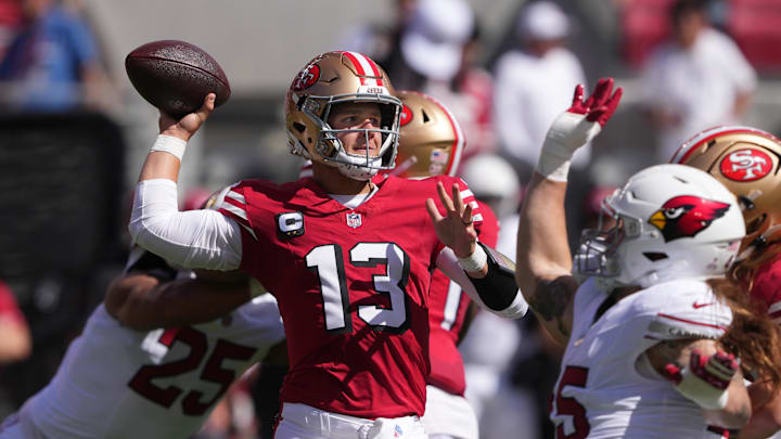 Oct 6, 2024; Santa Clara, California, USA; San Francisco 49ers quarterback Brock Purdy (13) passes against the Arizona Cardinals during the first quarter at Levi's Stadium. Mandatory Credit: Darren Yamashita-Imagn Images