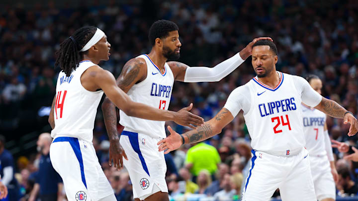 Apr 28, 2024; Dallas, Texas, USA;  LA Clippers guard Terance Mann (14) and LA Clippers forward Paul George (13) and LA Clippers guard Norman Powell (24) react  during the first quarter against the Dallas Mavericks during game four of the first round for the 2024 NBA playoffs at American Airlines Center. Mandatory Credit: Kevin Jairaj-USA TODAY Sports